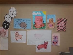 Student drawings of pigs in the Finch main office 
